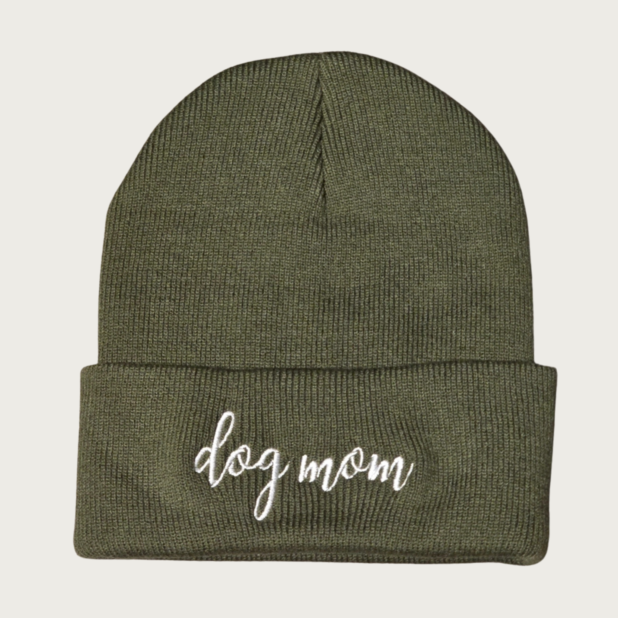 Deep olive green beanie (winter cap) with 'dog mom' in lower case letters white script embroidered on the cuff.