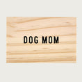 Load image into Gallery viewer, Top of this necklace's wooden gift box, which reads "DOG MOM" in black.
