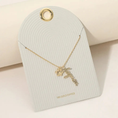 Load image into Gallery viewer, Alternate view of the Dog Mom Necklace on an ivory jewelry card with '18K Gold Dipped' text.
