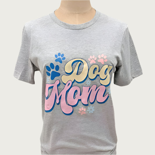 Gray t-shirt with multicolored pastel 'Dog Mom' text and paw prints in fun, 60's retro wide font. 