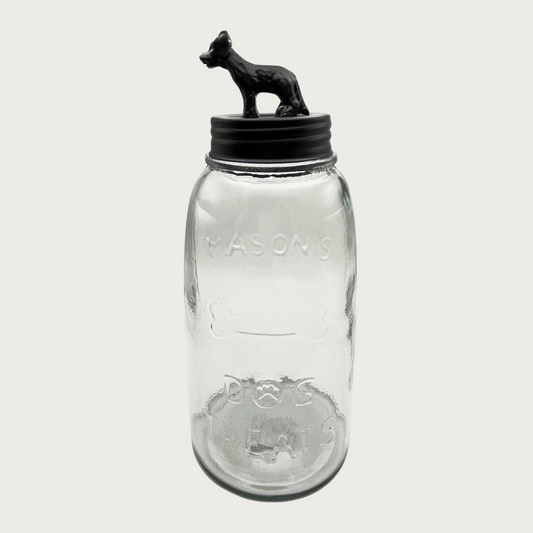Clear glass mason style treat jar with dark bronzed metal lid. Lid has a 3D figure on top that's about 2.5" tall, and resembles a German shepherd-type dog.