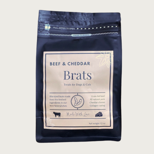 A 12 oz black bag of Beef and Cheddar Brats treats for dogs and cats. Made with Love in the Wet Nose Kitchen. Features grass fed beef, all natural pork, cheddar cheese, and collagen casing.