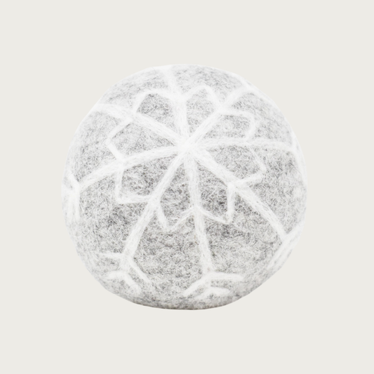 Pale gray felted wool ball with a white snowflake design covering the entire ball.