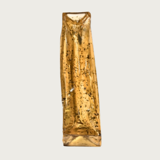Rectangular stick-shaped, yellowish colored dog chew. It is transparent, and the flakes of parsley are easy to see.