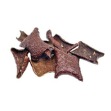 Close-up of a small pile of Wet Nose Pork Crispies treats. They are dark brown, thin squares about 2.5" wide, with a bumpy texture & curled edges.