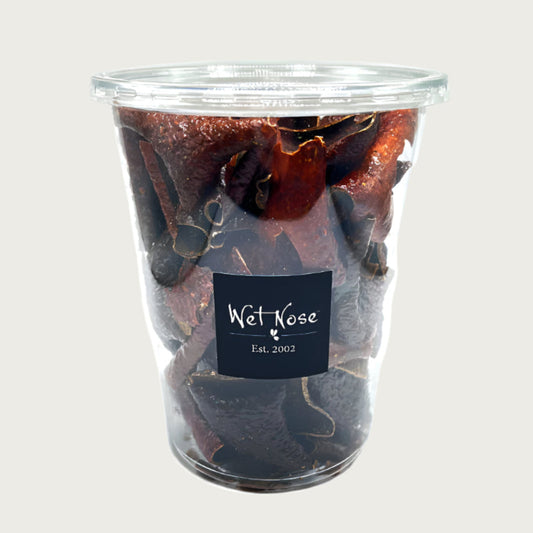 4 oz plastic container with lid, of Wet Nose Pork Crispies dog & cat treats. Product inside is dark brown, thin squares.