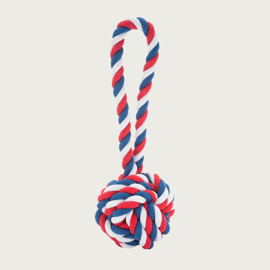 Red, white, and blue rope dog toy. It has a large ball at the bottom and long rope handle.