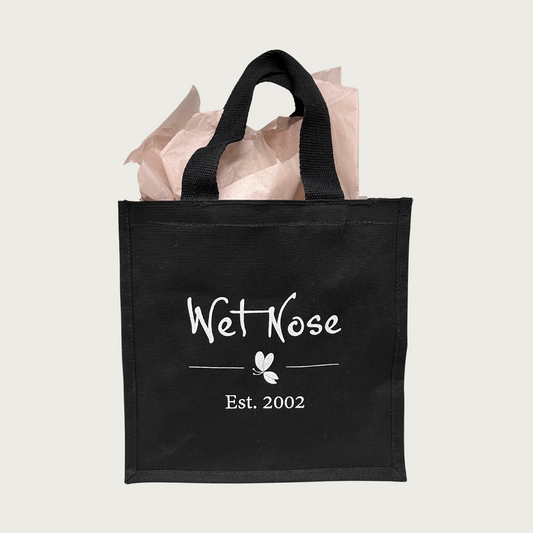 Black tote bag with Wet Nose logo in center, in white text.