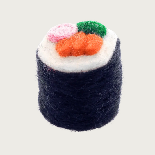 Wool cat toy that looks like a sushi roll. The exterior is black, like a seaweed wrap, on top it's white (like rice), with pink (ginger), green (wasabi), and orange (salmon) "fillings". 