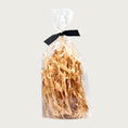 Load image into Gallery viewer, 6 oz clear cellophane bag of Wet Nose exclusive Turkey Twists dog treats, tied with black ribbon. Treats inside are tan colored, thin, narrow strips.
