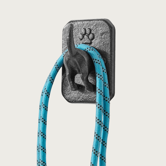 Image of the decorative dog tail hook, with a leash draped around it.