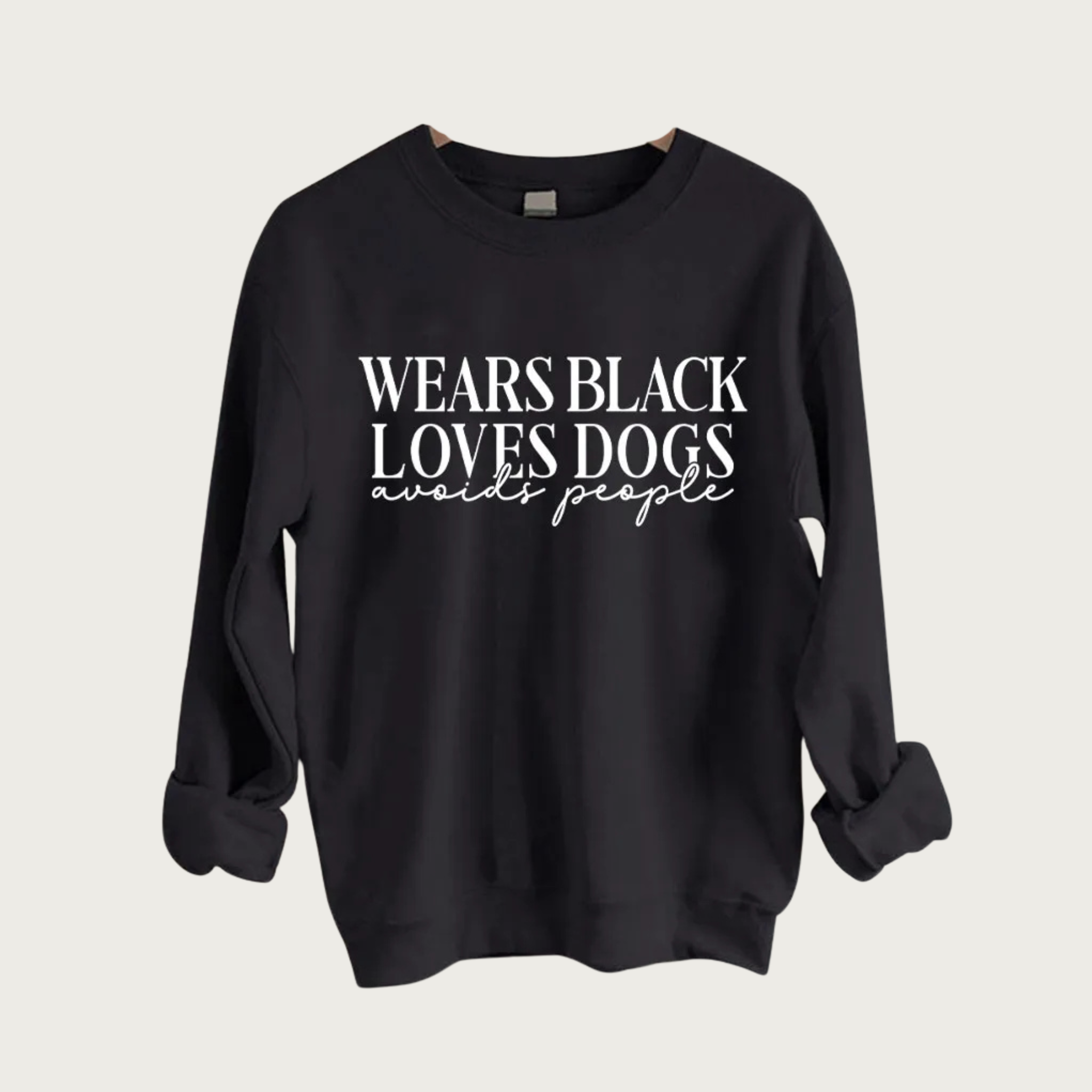 Black crewneck sweatshirt with white text in center that reads: "Wears Black, Loves Dogs, Avoids People" First two lines are all caps serif font, last line is lower case script.