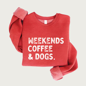 Heathered cranberry red crewneck sweatshirt, with "Weekends, Coffee & Dogs" on chest in large, all caps, distressed white text.
