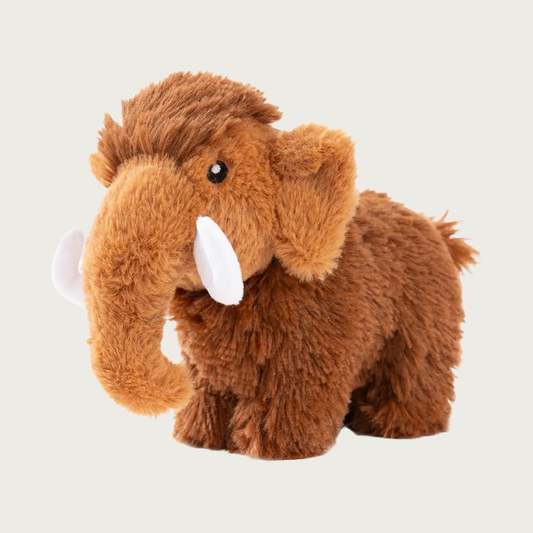 Plush dog toy shaped like a wooly mammoth. Its body is covered in brown faux fur, it has white tusks and embroidered black & white eyes.