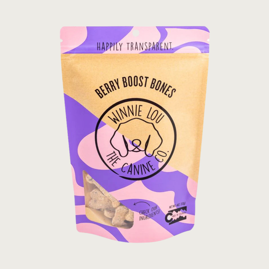 Purple, pink & beige bag of Berry Boost Bones dog treats with simple illustrated line logo for Winnie Lou the Canine Co. in the center. Happily Transparent. Made in Colorado.