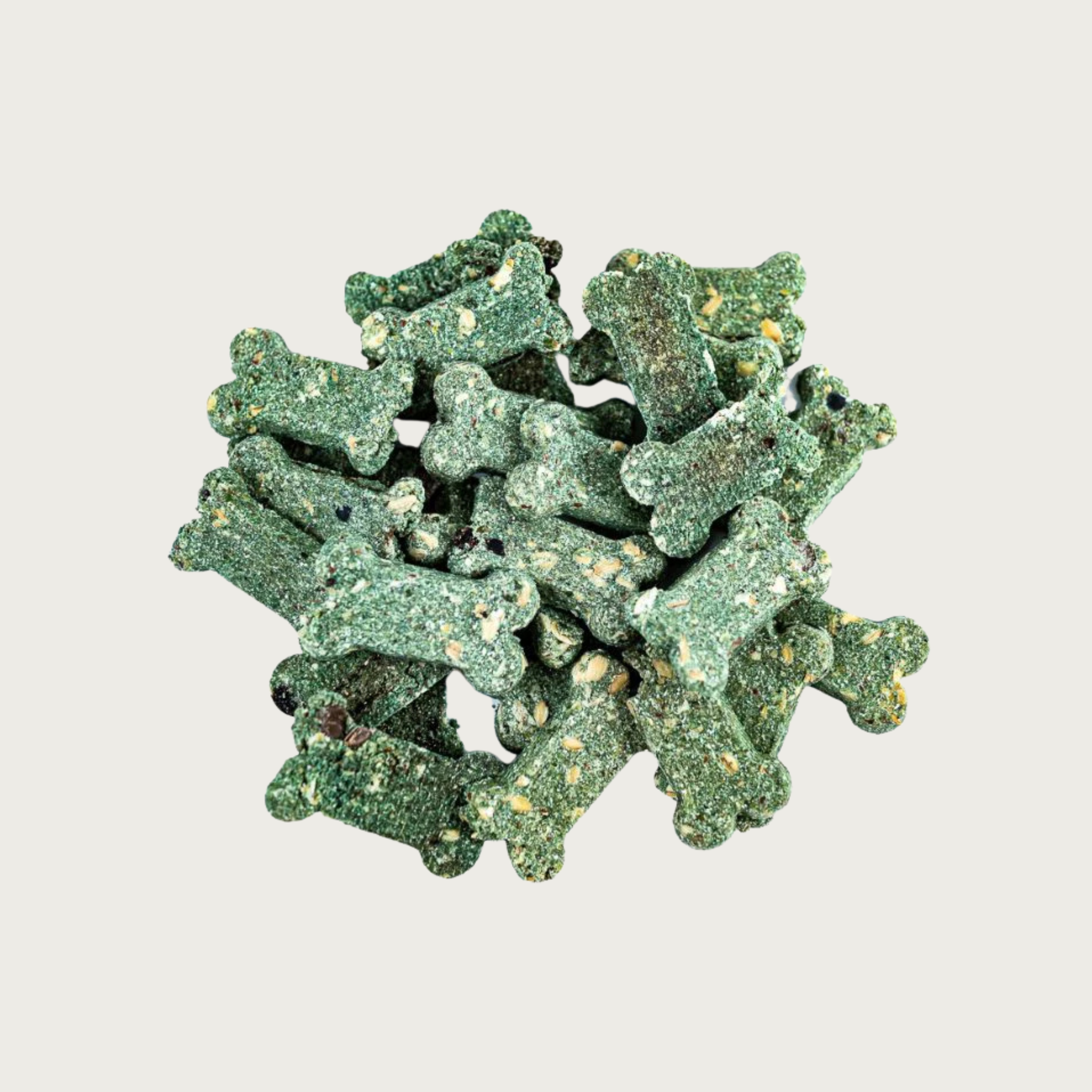 Closeup of a small pile of Minty Breath Bones dog treats. They are dog bone shaped, deep green in color, with a grainy texture.