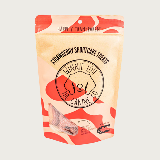 Coral & beige bag of Strawberry Shortcake dog treats with simple illustrated line logo for Winnie Lou the Canine Co. in the center. Happily Transparent. Made in Colorado.