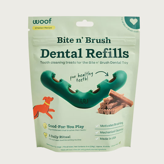 Woof Bite n' Brush Dental Refills. Tooth cleaning treats for the Bite n' Brush Dental Toy. Chicken Recipe. Good-for-you play. A daily ritual. Motivates Brushing. Mechanical Cleaning. Made in USA. Wide V-shaped toy is pictured in the center, with a stack of dental refill treat sticks next to it.