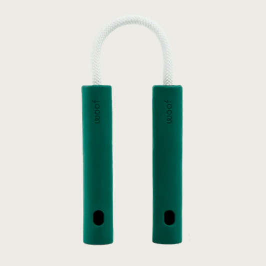 Nomchuck dog toy that looks like a short set of the nunchucks martial arts weapon. The two handles are dark green rubber, and connected with a short length of white rope. Each handle has a small hole at the bottom.