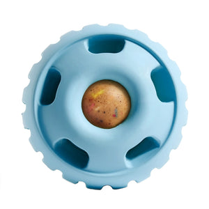 Light blue, round Pupsicle toy. Center has a small, depressed, round open area for dog to access a treat. Around this opening, are 5 smaller slot-type openings (called "drool slots"), to provide additional access and collect excessive drool. Bottom half of toy is solid rubber with an indentation to twist toy apart.