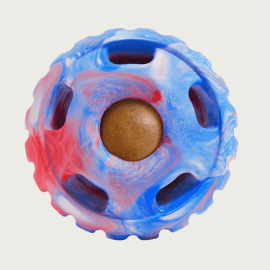Red, white, & blue marbled, round Pupsicle toy. Center has a small, depressed, round open area for dog to access a treat. Around this opening, are 5 smaller slot-type openings (called "drool slots"), to provide additional access and collect excessive drool. Bottom half of toy is solid rubber with an indentation to twist toy apart.