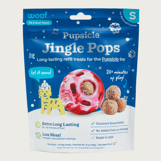 10 ct bag of small Woof Pupsicle Jingle Pops, long-lasting refill treats for the Pupsicle toy. Extra long lasting, less mess. Image of holiday red & white marbled Pupsicle toy is in center, with refill pop inside, with sample pops clustered to the right. They are round, peanut butter colored, smooth balls, coated with coconut flakes.