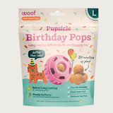 7 ct bag of large Woof Pupsicle Birthday Refill Pops, long-lasting refill treats for the Pupsicle toy. "Better than cake!" Extra long lasting, ready to party. Image of pink Pupsicle toy is in center, with refill pop inside, with sample pops clustered to the right. They are round, peanut butter colored, smooth balls, with dog-safe sprinkles inside.