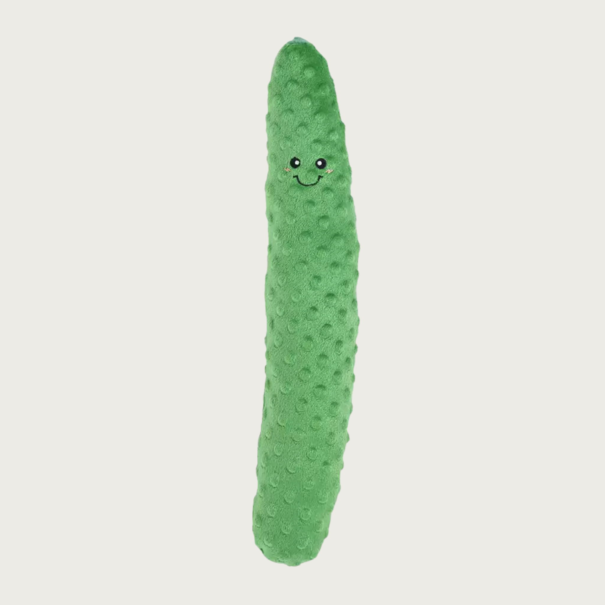 A green textured plush pickle dog toy with a cute embroidered smiley face, shown vertically.