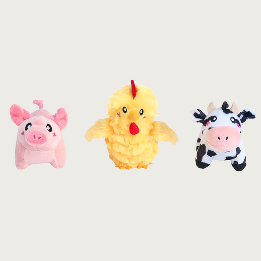 Three small, plush dog toys shaped like a pink pig, yellow chicken, and black & white cow.