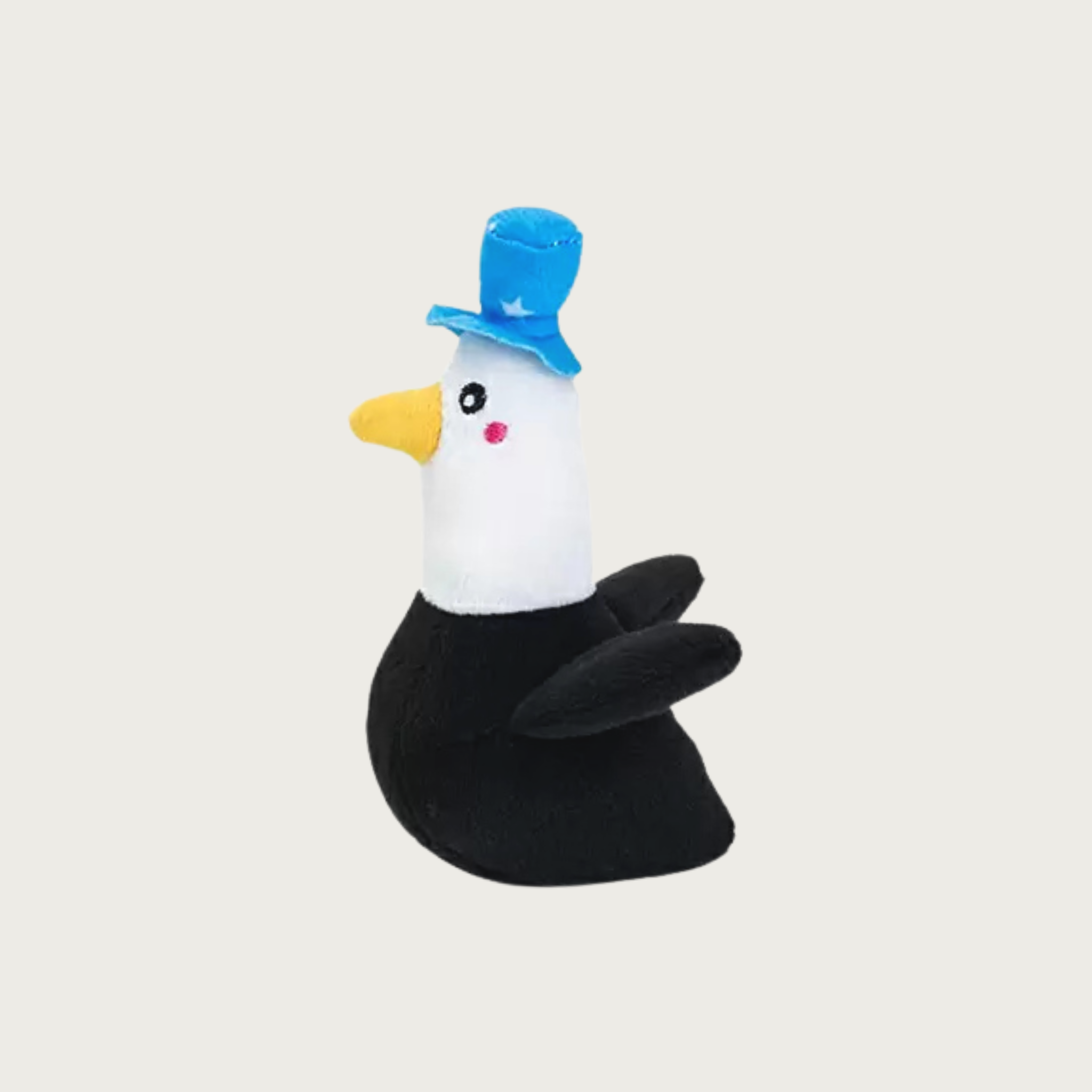A small, plush bald eagle dog toy wearing a medium blue top hat with white stars on it.