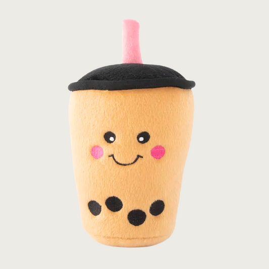 Plush dog toy resembling a tan bubble tea cup with a smiley face and a pink "straw".
