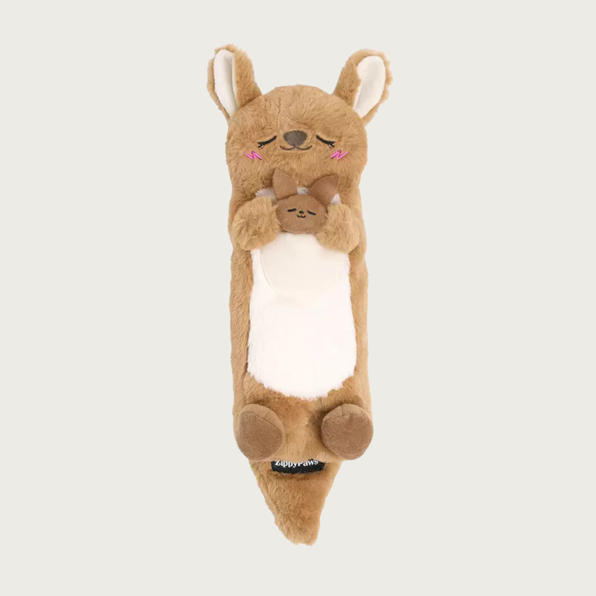 A long, plush kangaroo dog toy, laying on its back and holding its baby joey between its front paws. Its body is tan with cream inner ears & belly and it has a sleepy embroidered facial expression.