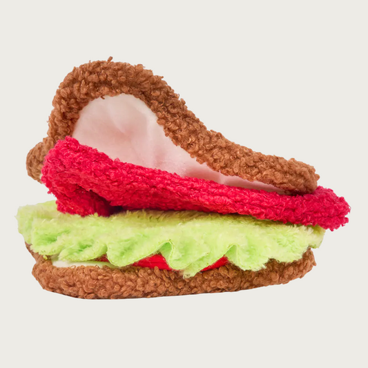 Side view of the BLT sandwich dog toy, with brown, red, and green layers that can be opened up to hide treats.