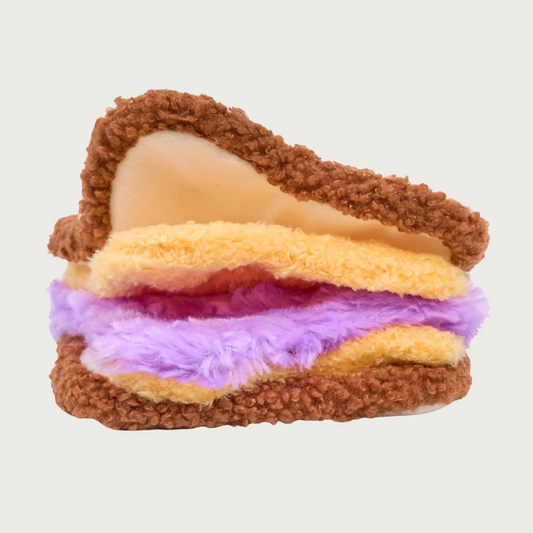 Side view of the PB & J sandwich dog toy, with brown, tan, and purple layers that can be opened up to hide treats.