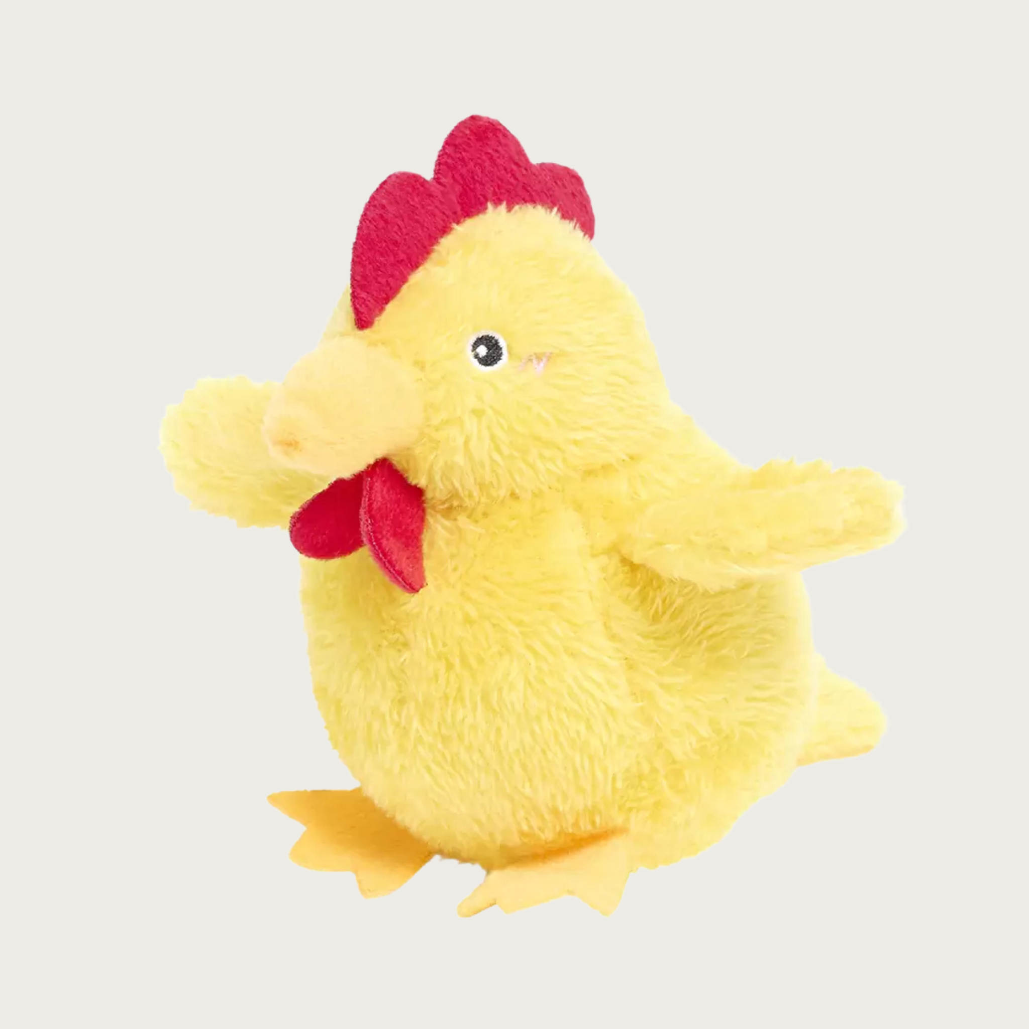 A yellow plush chicken dog toy with a red comb and wattle, sitting up.