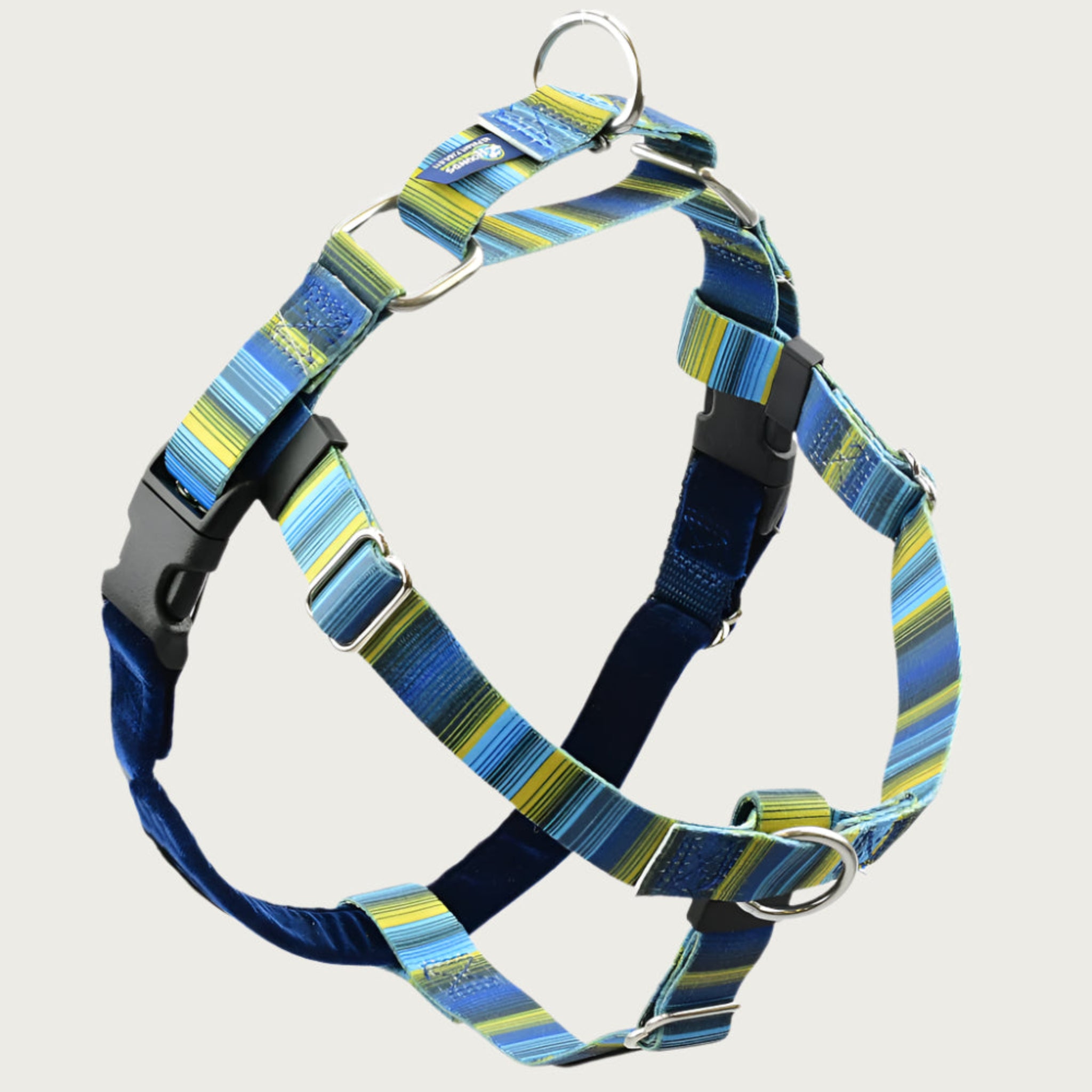 Dog harness with shades of blue & yellow-green striped straps on the front and sides; loop on dog's back is same color & pattern. Chest strap is navy blue velvet. There are 2 black plastic clips, which fasten behind each front leg. 