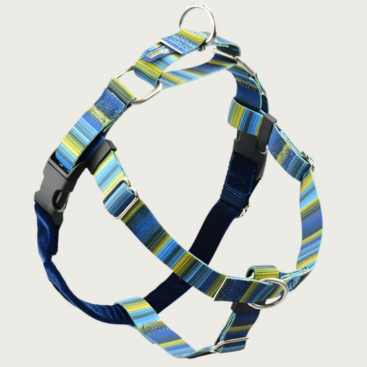 Dog harness with shades of blue & yellow-green striped straps on the front and sides; loop on dog's back is same color & pattern. Chest strap is navy blue velvet. There are 2 black plastic clips, which fasten behind each front leg. 