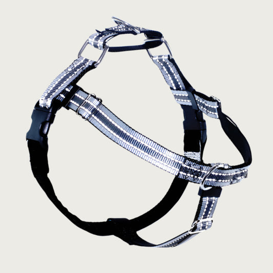 Dog harness with gray & white reflective stripes on the front, side, and back nylon straps; chest strap is black velvet. There are 2 black plastic clips, which fasten behind each front leg. 