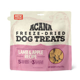 3.25 oz beige & pink bag of Acana Freeze-Dried Dog Treats, Lamb & Apple Recipe. 5 calories per treat, made with 3 simple ingredients. Small transparent window show product inside; small tan-colored, cube shaped treats.