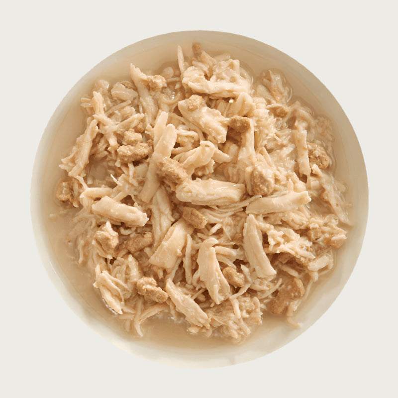 A bowl of Aujou by RAWZ Chicken Breast & Duck recipe, showing large chunks of chicken with smaller shreds and small pieces of duck.