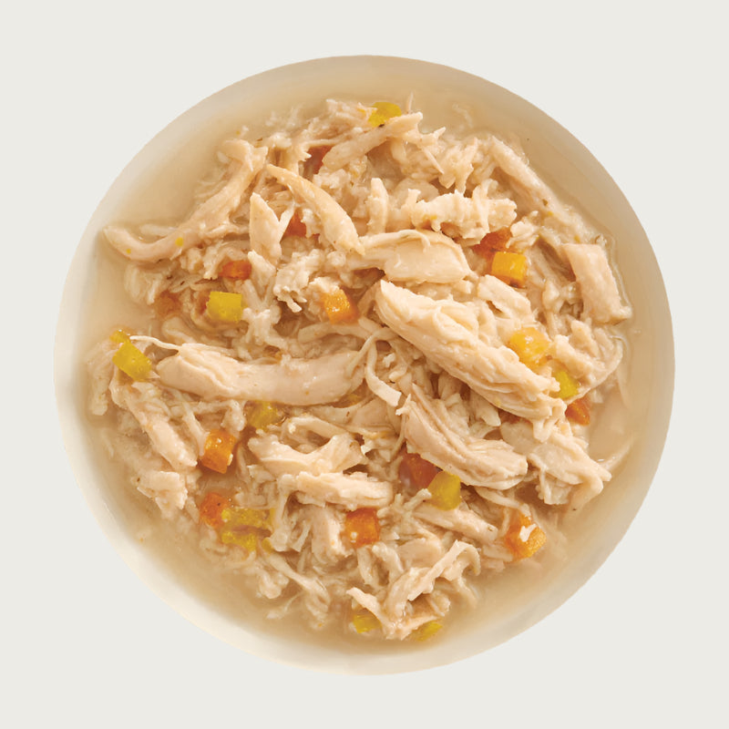 A bowl of Aujou by RAWZ Chicken Breast & Pumpkin recipe, showing large chunks of chicken with smaller shreds and small cubes of pumpkin