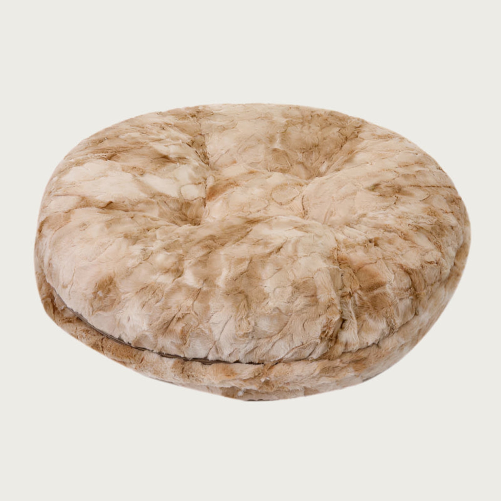 Side view of the Bagel Bed in Beige Rabbit. A ring of fabric goes along the center edge of the bed, hiding the zipper.