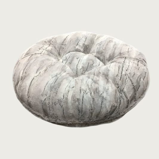 Round, plush pet bed made with faux fur in shades of light gray and cream in a subtle striped pattern.