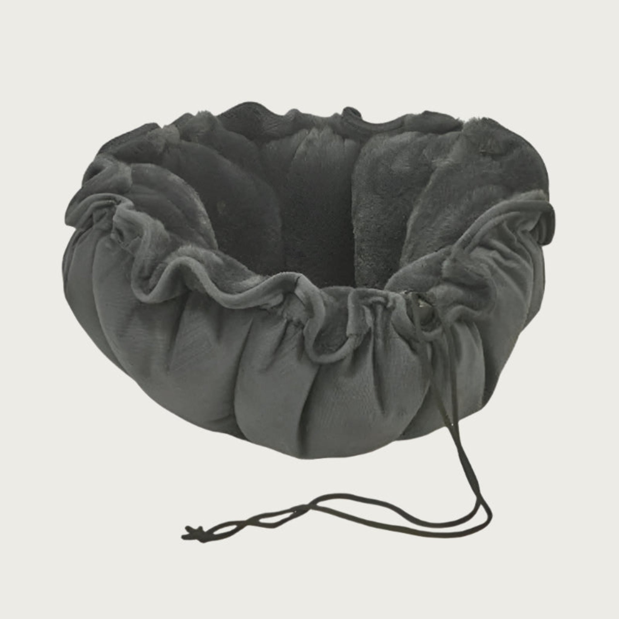 Dark gray, round pet bed with cord sewn into top edge, so the bed can be cinched into a nest or relaxed to lay flat.
