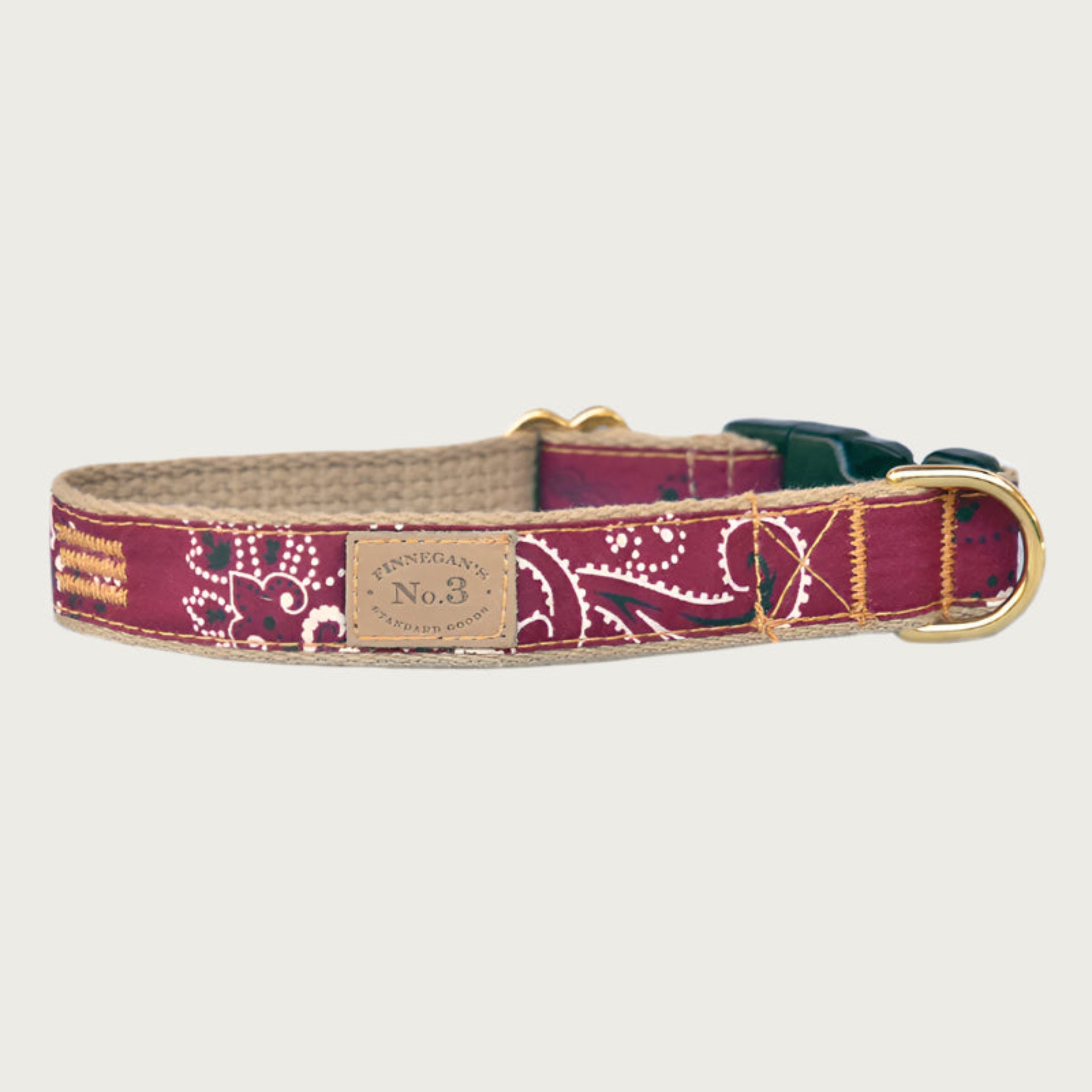 Dog collar with black & white bandana print on a maroon colored background.