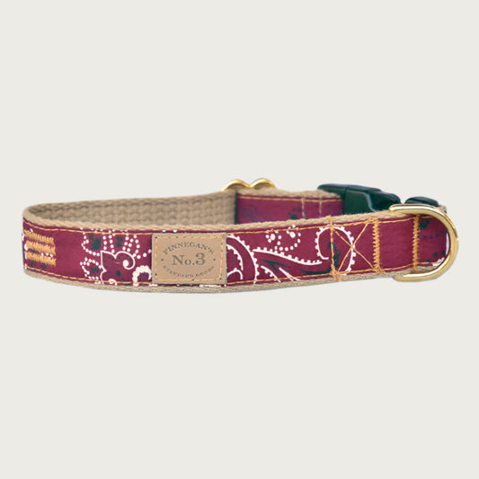 Dog collar with black & white bandana print on a maroon colored background.