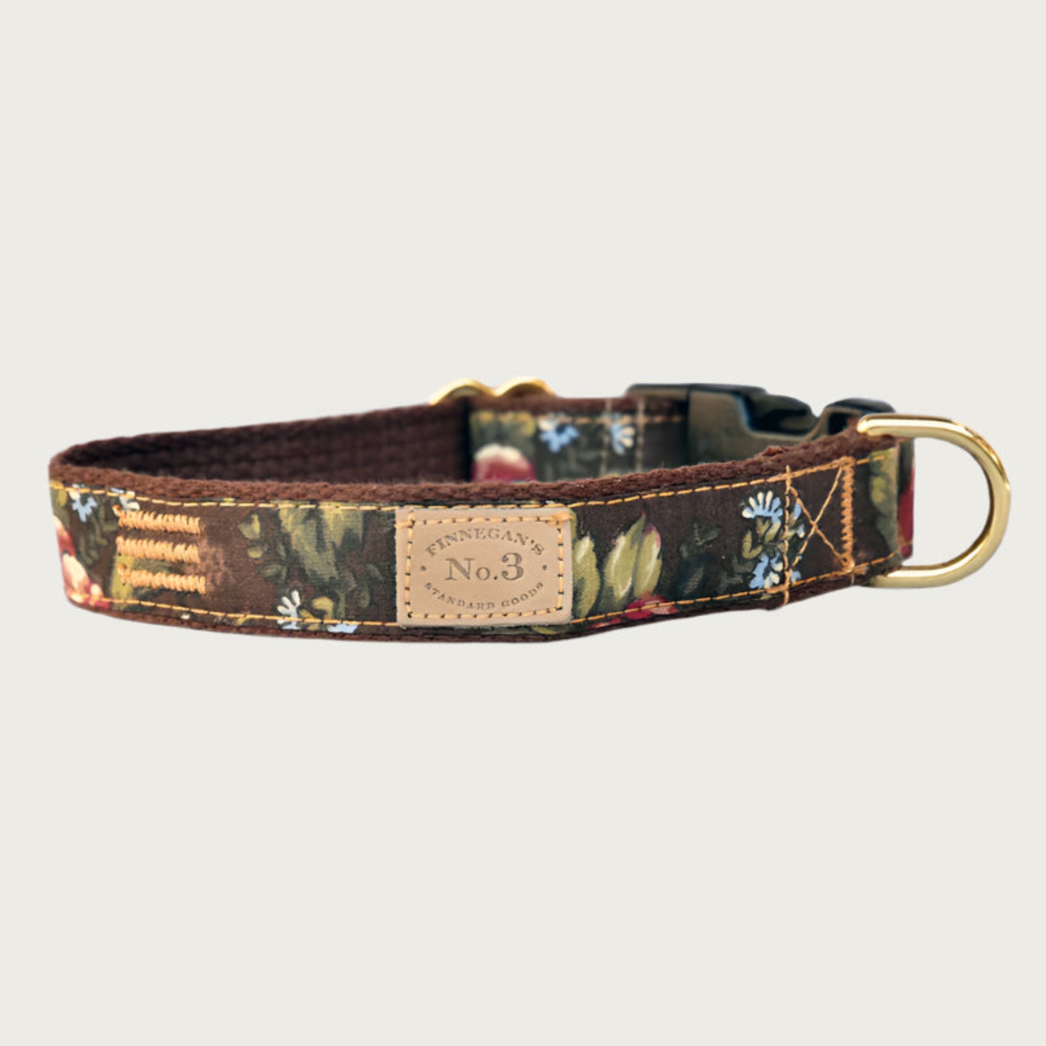 Dog collar with a vintage, English Garden, floral pattern in muted shades of green, blue, white and burgundy, on a chocolate brown background.