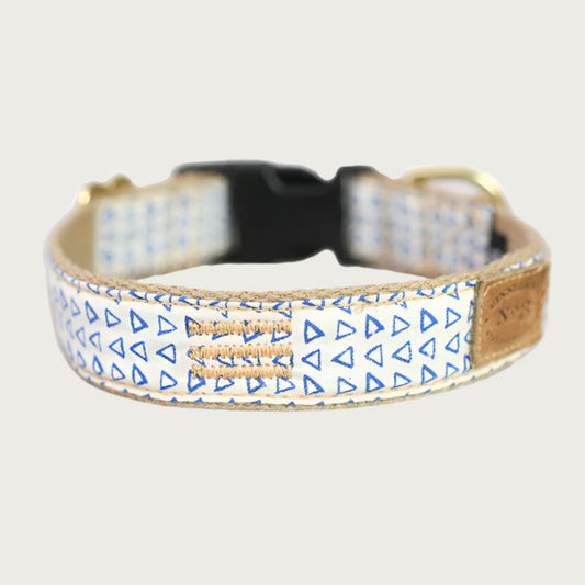 Dog collar with small, blue outlined triangle, repeating pattern with a creamy white base color.