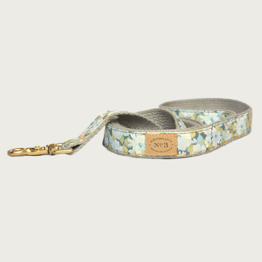 Dog leash featuring a subtle, large sized floral pattern in shades of muted blue, green and white.