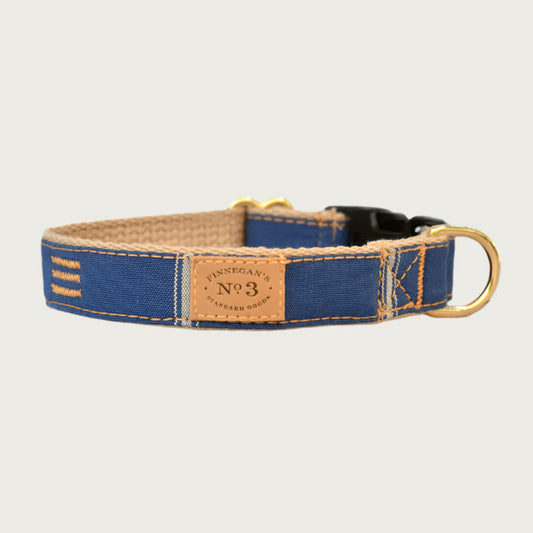 Dark denim blue dog collar with sparse tan vertical stripes.